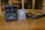 New Never Used Genuine Nikon MH-23 Battery Charger And EN-EL9A. Fixed Price $30.00.